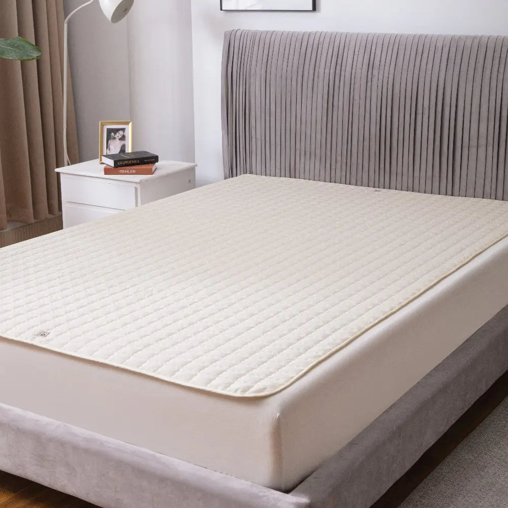 Mattress pad on a bed in a bedroom setting