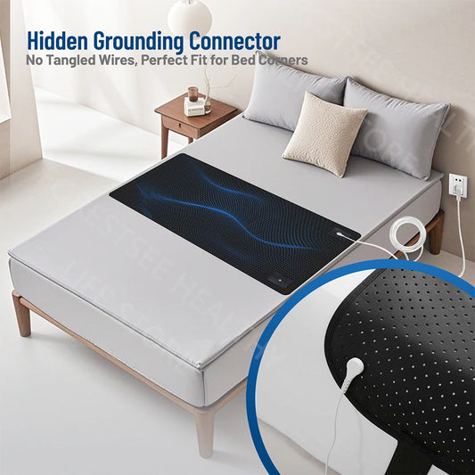 Mattress pad with hidden grounding connector on a bed in a bedroom setting