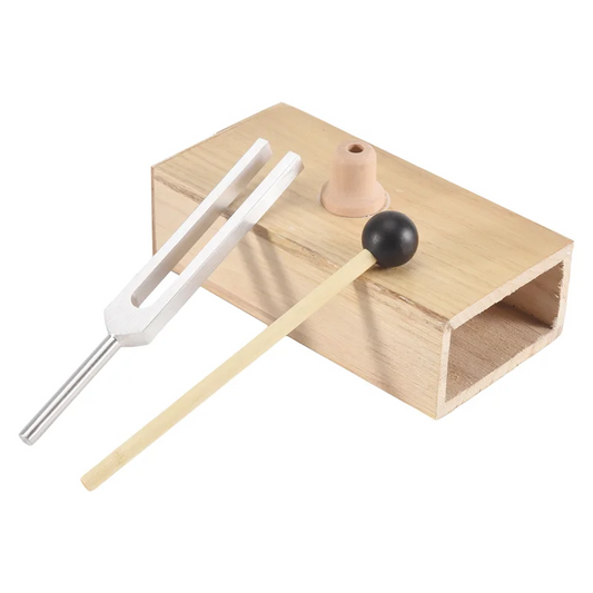 Wooden tuning fork with metal prongs on a white background