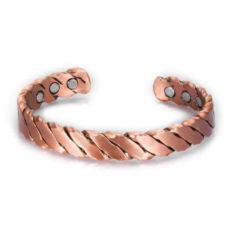 Copper bracelet with a wavy design on a white background