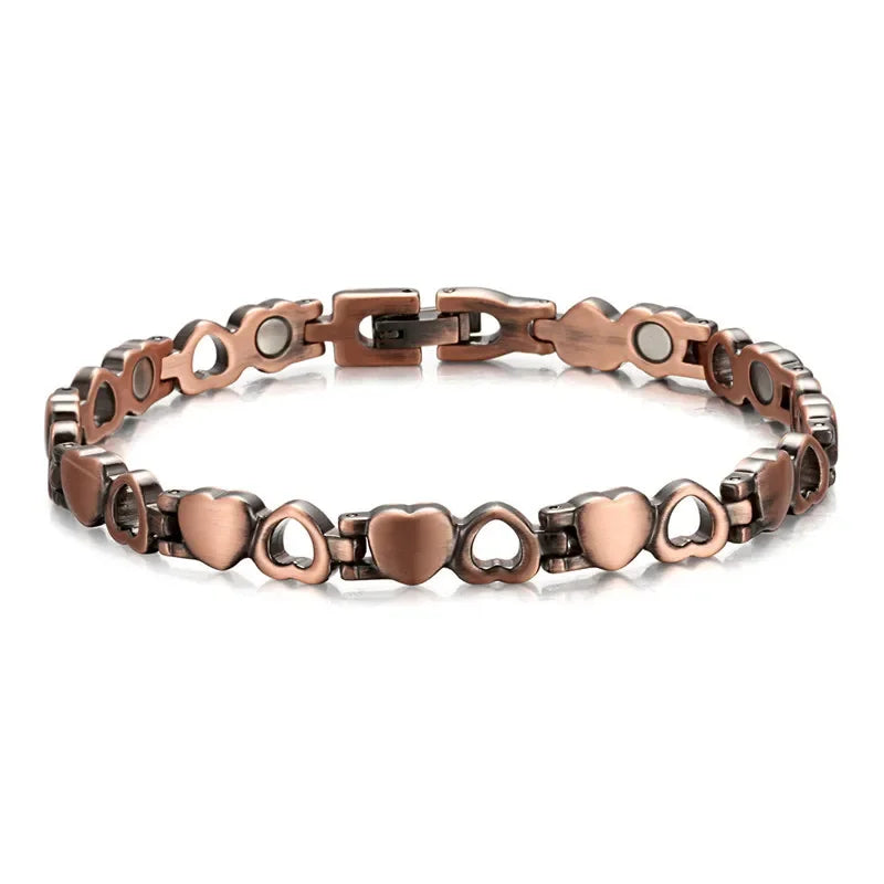 Cooper bracelet with heart and circle designs on a white background